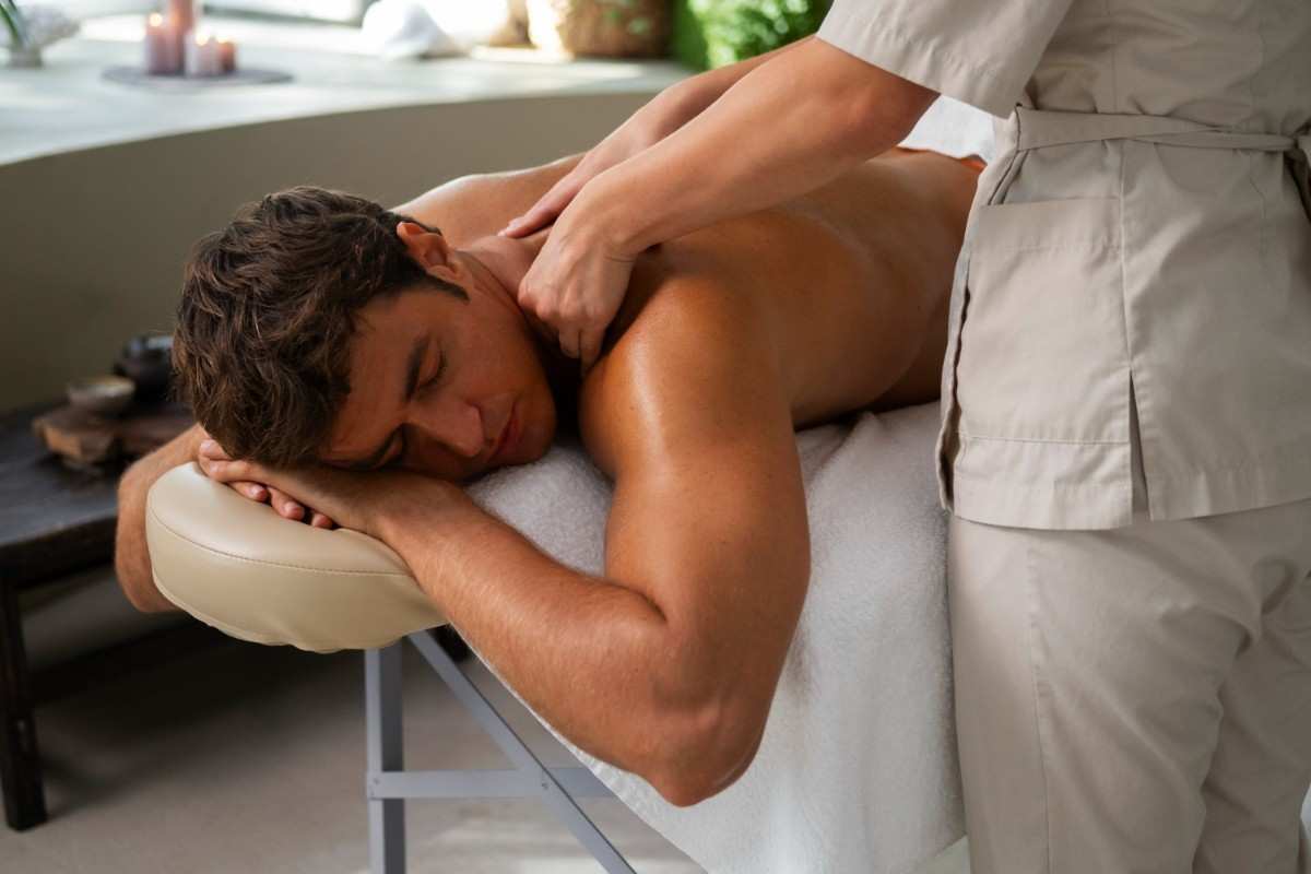 Therapist applying deep tissue massage to client’s back for pain relief