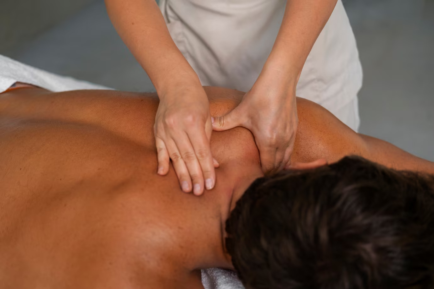 client receiving back massage in a professional spa