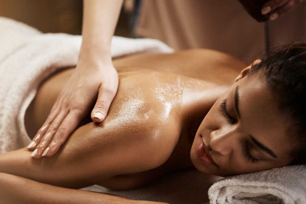 Essential oils and candle setup for aromatherapy massage near Marol